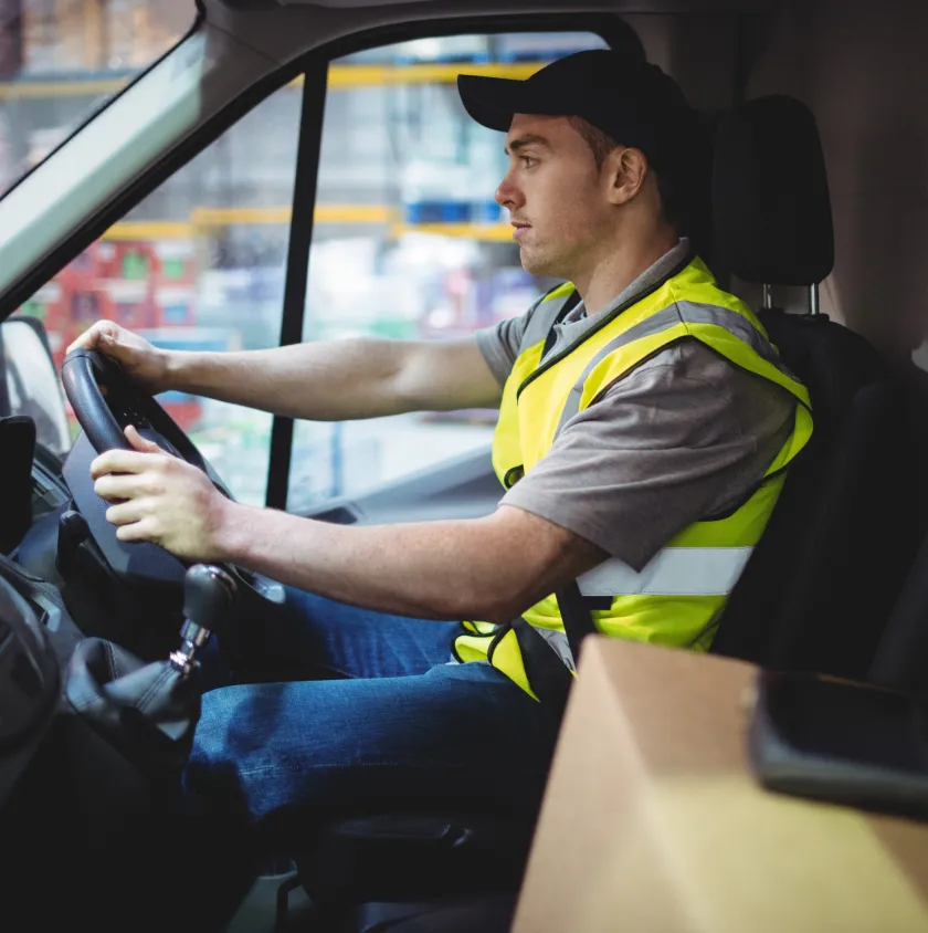 A driver at the wheel of a vehicle