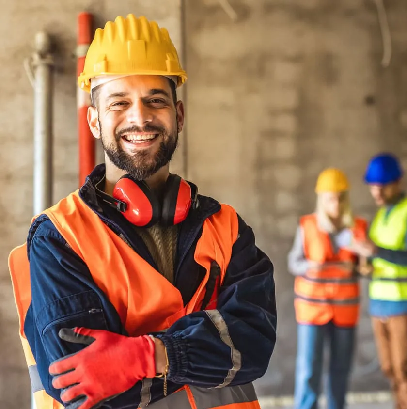 A construction worker in a hard hat and hi-vis jacket